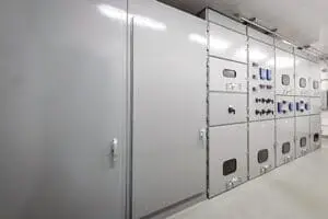 a large white cabinet with black and red buttons